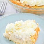 slice of copycat Marie Callender's banana cream pie on a blue plate.