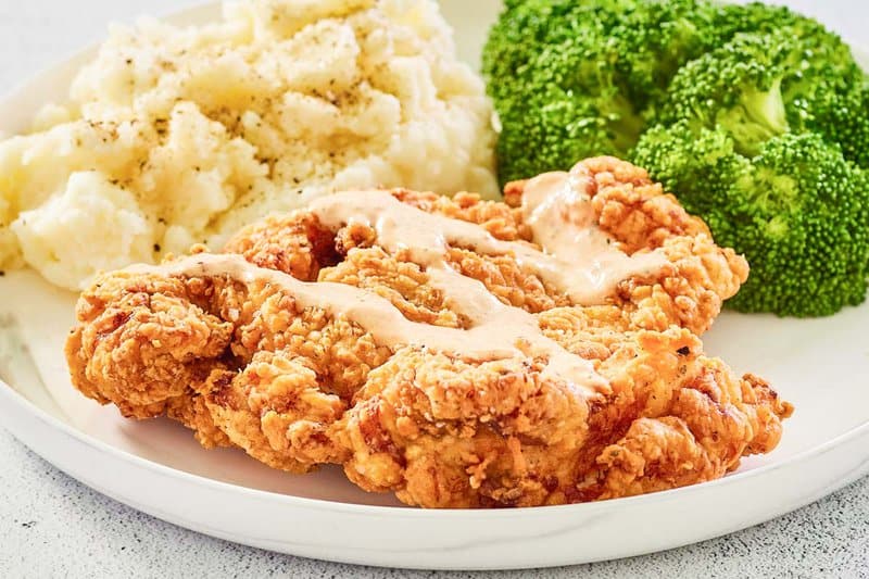 copycat Outback Steakhouse bloomin fried chicken with bloom sauce drizzled on top.