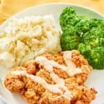 copycat Outback Steakhouse bloomin fried chicken, broccoli, and mashed potatoes on a plate.