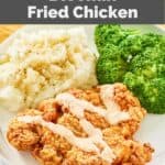 homemade Outback bloomin' fried chicken, potatoes, and broccoli on a plate.