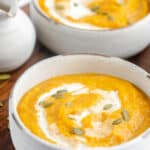 two bowls of copycat Panera autumn squash soup.