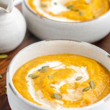 two bowls of copycat Panera autumn squash soup.