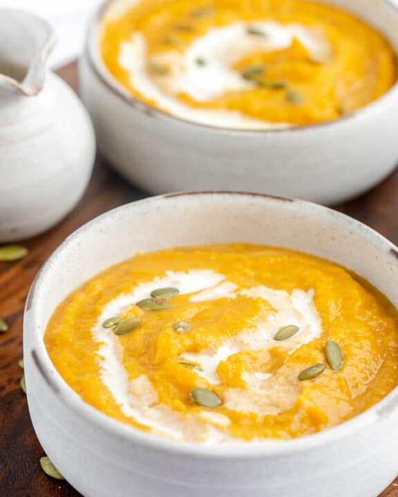 two bowls of copycat Panera autumn squash soup.