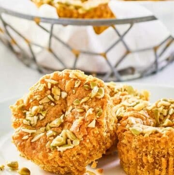 copycat Starbucks pumpkin cream cheese muffins on a plate and in a basket.