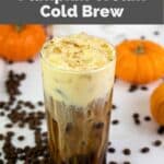 homemade Starbucks pumpkin cream cold brew drink and small pumpkins.