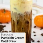 homemade Starbucks pumpkin cream cold brew and two small pumpkins.
