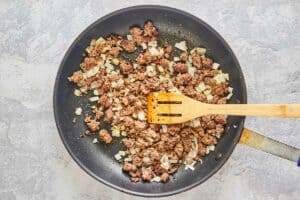 browned meat and onions in a skillet.