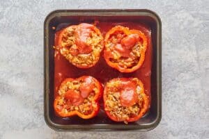 stuffed bell peppers in a baking dish.
