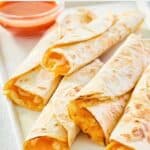 several homemade Taco Bell cheesy roll ups on a platter.
