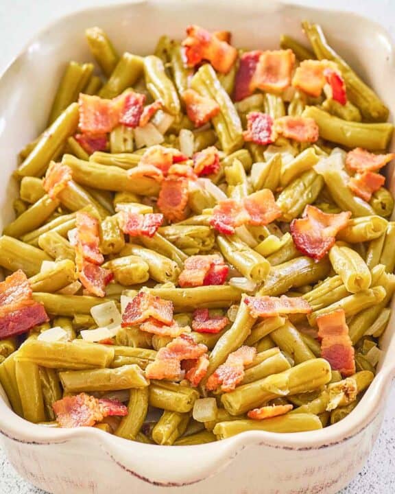 copycat Texas Roadhouse green beans with bacon and onions in a serving dish.