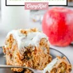 apple spice cake slice on a black plate.