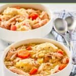 chicken and dumplings in white bowls and two spoons.