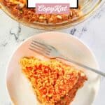 overhead view of country beef pie slice and a fork on a plate.