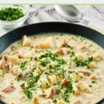 clam chowder garnished with parsley in a bowl.