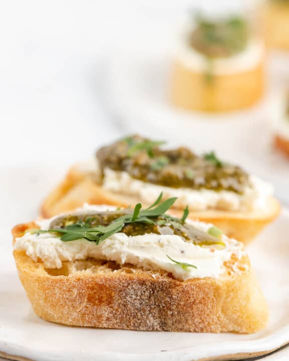 two goat cheese crostini canapes with pesto.
