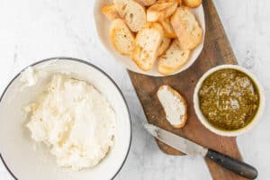 spreading goat cheese mixture on crostini.