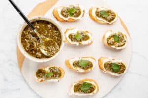 overhead view of goat cheese pesto crostini canapes on a tray.