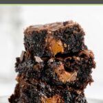 three milky way brownies stacked on a white plate.
