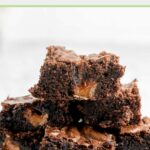 milky way brownies stacked on a white plate.
