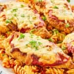 copycat Olive Garden chicken parmigiana and pasta on a platter.