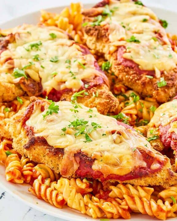 copycat Olive Garden chicken parmigiana and pasta on a platter.
