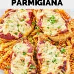 homemade Olive Garden chicken parmigiana over pasta on a platter.