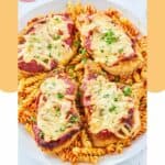 four homemade Olive Garden chicken parmigiana and pasta on a platter.