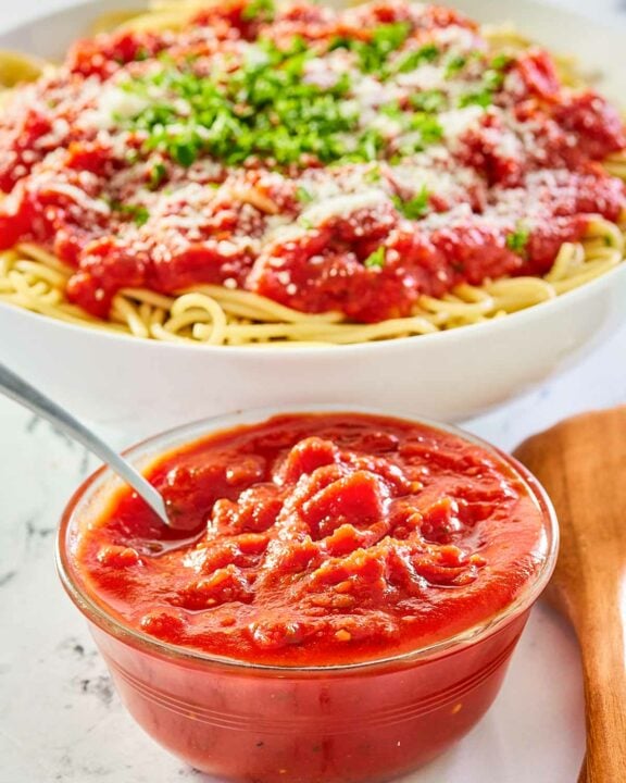 copycat Olive Garden marinara sauce in a bowl and over spaghetti.