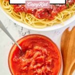 overhead view of homemade Olive Garden marinara sauce on spaghetti and in a bowl.
