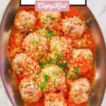 overhead view of homemade Olive Garden meatballs and marinara in a copper skillet.