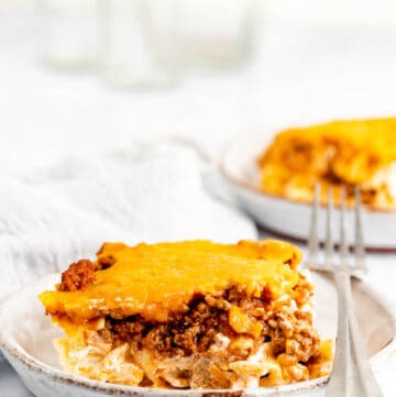 sour cream noodle bake serving and a fork on a plate.