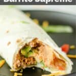 closeup of a copycat Taco Bell burrito supreme on a black plate.