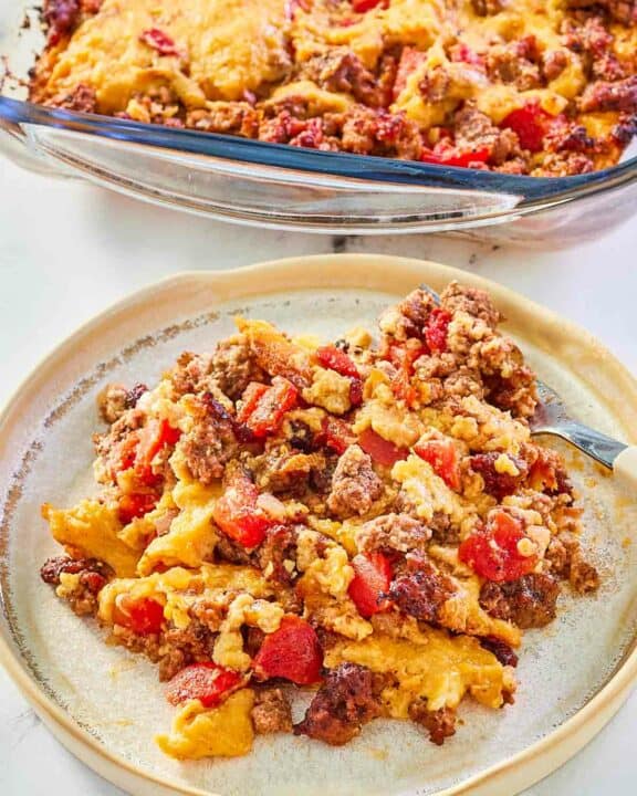 beef tamale casserole in a baking dish and a serving on a plate.