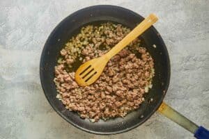 browned ground beef and onions in a skillet.