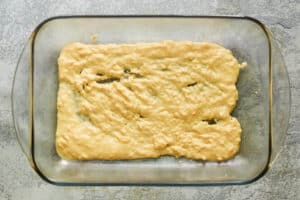 cornmeal mixture in the bottom of a glass baking dish.