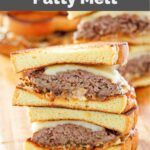 copycat Whataburger patty melt sandwiches on a wood cutting board.