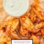 overhead view of homemade Wingstop ranch in a bowl and some chicken wings.