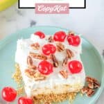 banana split cake topped with cherries and pecans.