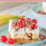 slice of banana split cake on a blue plate and a banana.