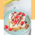 banana split cake slice on a blue plate.