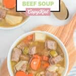 overhead view of homemade Campbell's vegetable beef soup in a bowl on a board.