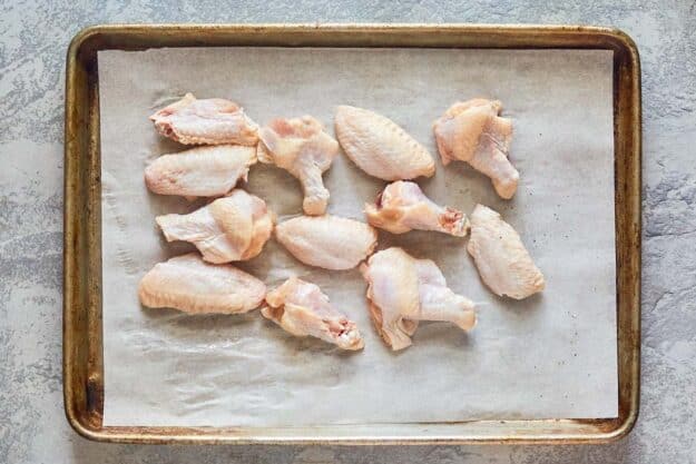 chicken wing flats and drumettes on a baking sheet.