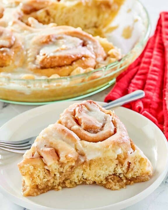 copycat Cracker Barrel cinnamon roll pie slice on a plate in front of the pie.