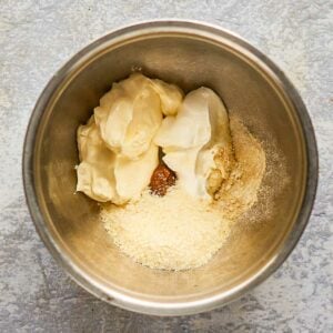 creamy caesar dressing ingredients in a mixing bowl.