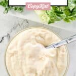 overhead view of creamy caesar salad dressing in a small bowl.