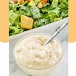 a small bowl of creamy caesar salad dressing.