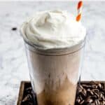 homemade Dunkin coffee coolatta surrounded by coffee beans.