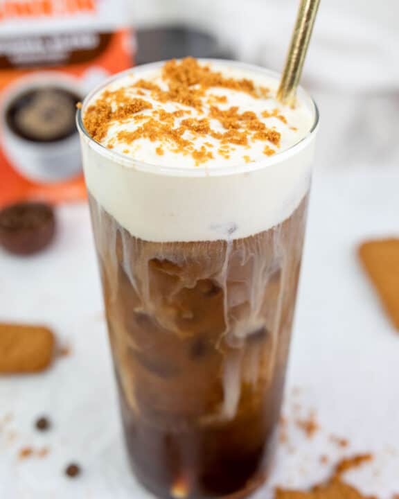copycat Dunkin cookie butter cold brew with cold foam and a straw.
