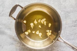 olive oil and garlic slices in a pan.