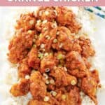 homemade Panda Express orange chicken over rice on a platter.